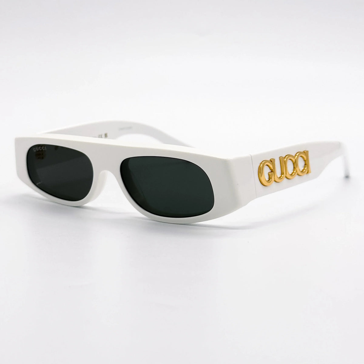 White Gucci luxury sunglasses with dark lenses and gold logo on the temple