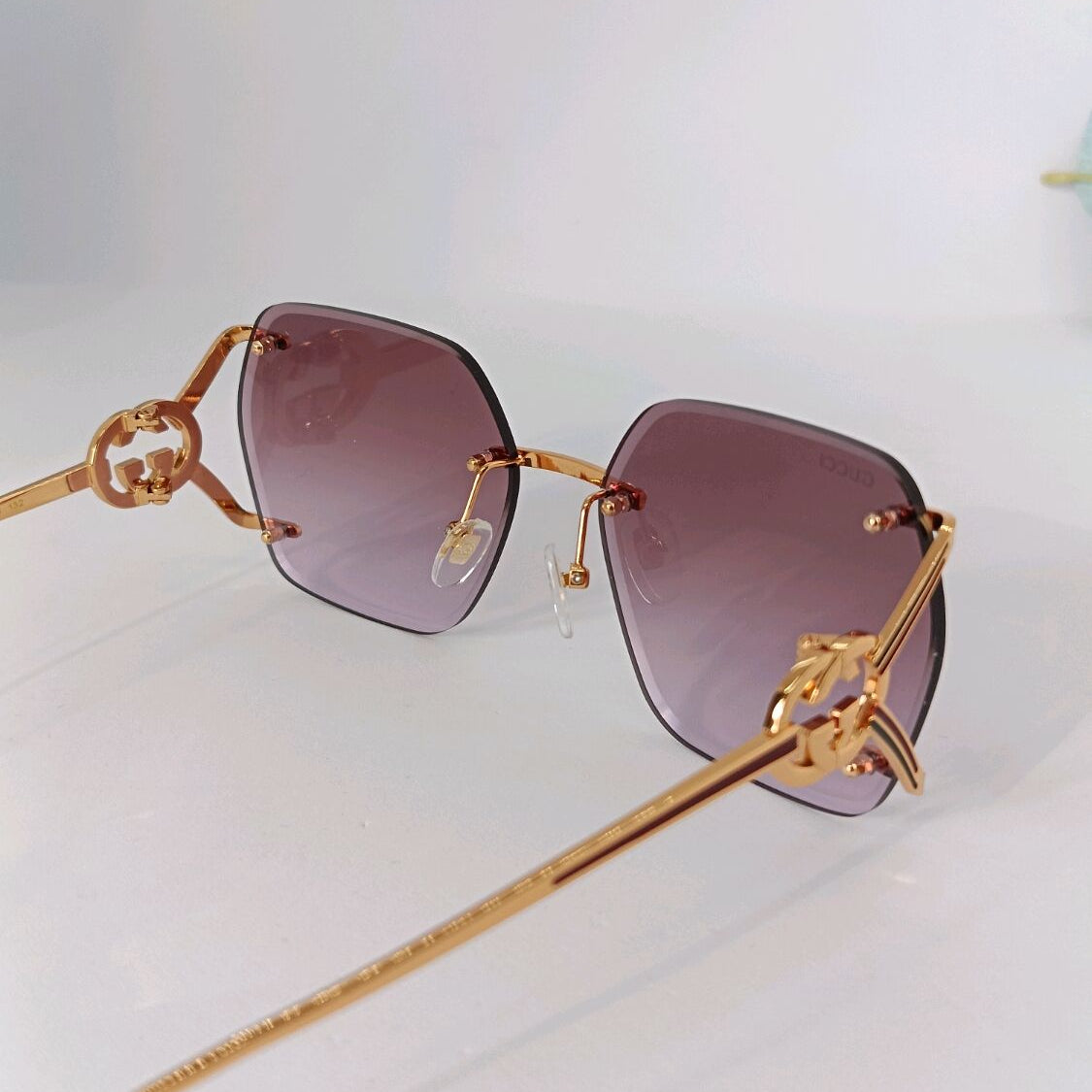 Gold-frame luxury sunglasses with purple gradient hexagonal lenses