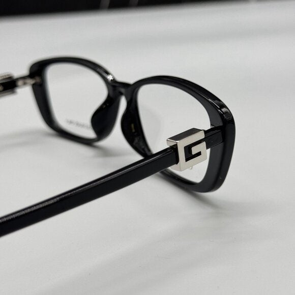 Black luxury eyewear frames with a silver metallic logo detail on the temple.